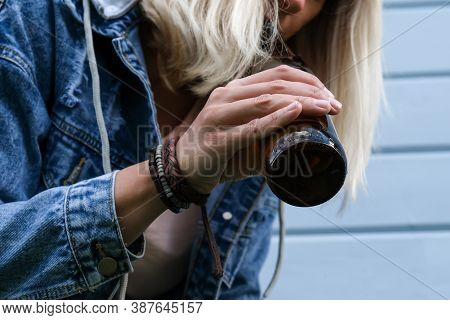 A Drunked Woman Dressed Punk, Informal Drinking Beer From A Brown Bottle, Alcohol Overdosage And Add