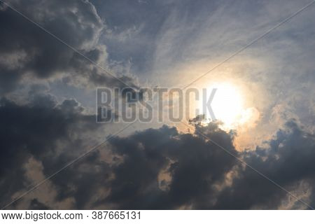The Bright Sun Breaks Through The Dark Clouds. Heavenly Landscape. Sunset Sky. High Quality Photo