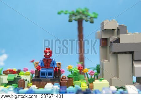 Florianopolis, Brazil. September 20, 2020: Spider Man Sitting On Bench Near The River Resting And Re
