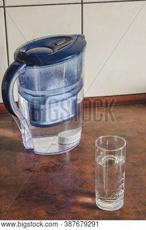 Water Filter Jug With Shungite Cartridge Inside On The Kitchen Counter. Shungite Cartridge For Clean