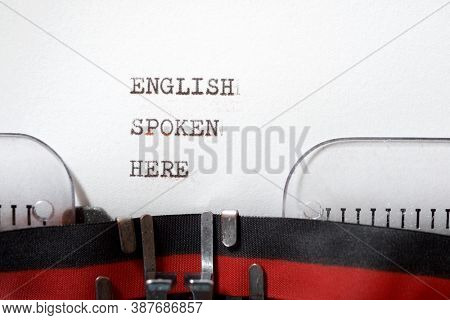 English spoken here phrase written with a typewriter.