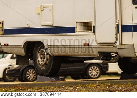 Caravan Leveling Block In Use. Leveler Ramp Chock Blocks For Rv Travel Trailer. Accessories For Moto