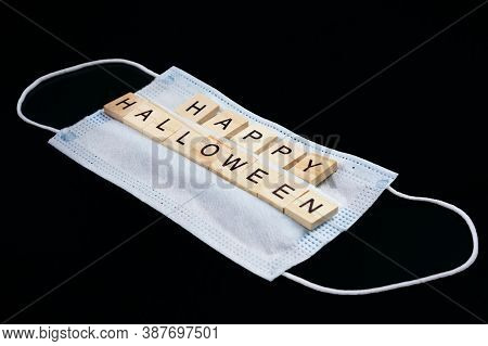 Medical Mask And Wooden Words Happy Halloween On Black. Halloween Background Decor Holiday Concept
