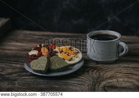 Chocolates With Dried Fruits And A Cup Of Espresso Coffee.