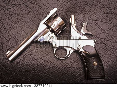 Automatic revolver is a repeating handgun that has a revolving cylinder containing multiple chambers and at least one barrel for firing