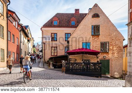 Visby, Sweden - July 27, 2020: City View Of A Cafe Restaurant On Cobblestone Street With Old Ancient