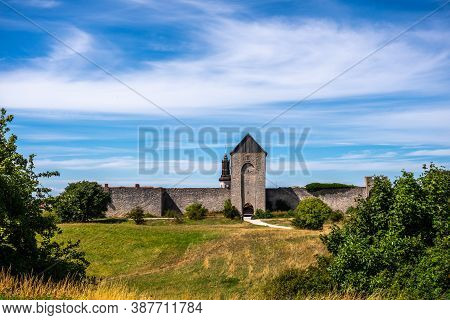 Beautiful Rural Summer View Of An Ancient Medieval Brick Tower And Defense Wall Surrounding The City