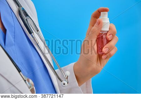 Female Doctor Holding A Sanitizer, Closeup. Nurse With A Stethoscope With Hand Disinfectant. Concept