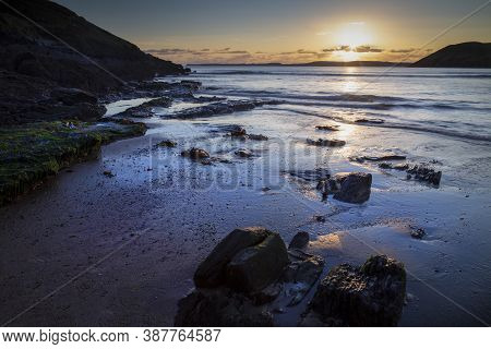 Low Water At Sunset On Manorbier Beach In West Wales, Uk