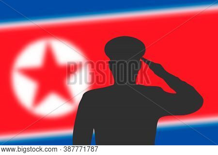 Solder Silhouette On Blur Background With North Korea Flag.