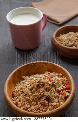 A Healthy Breakfast Of Multi-zilla Muesla And Cows Milk On A Black Background