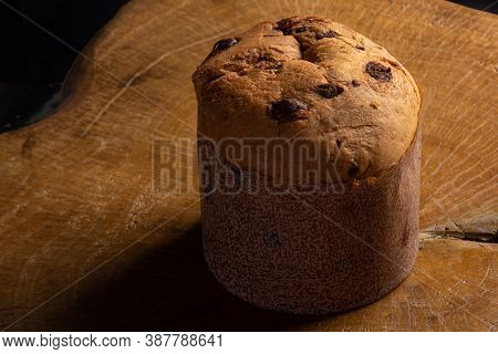 Panettone With Chocolate Chips On Rustic Wood With Black Background, Selective Focus.