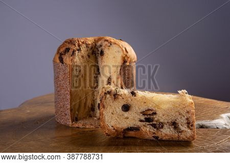 Panettone With Chocolate Chips On Rustic Wood With Gray Background, Selective Focus.