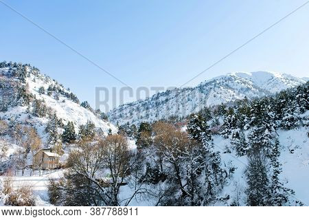 Beautiful Rock Mountains Covered With Snow In Winter In Sunny Weather In Uzbekistan Near The Resort 
