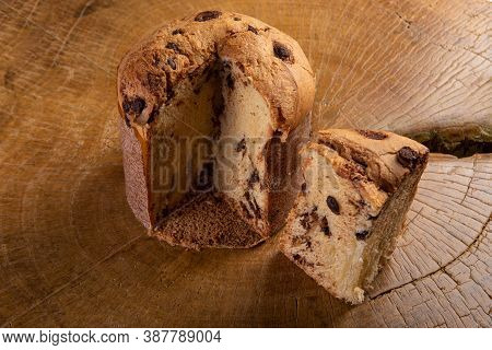 Panettone With Chocolate Chips On Rustic Wood Selective Focus.