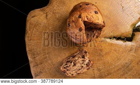 Panettone With Chocolate Chips On Rustic Wood, Top View