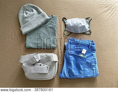 Matching Reusable Face Mask With Outfit. Green Sweater, Matching Cotton Face Mask, Blue Jeans And Gr