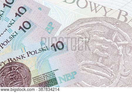 10 Polish Zloty Bills Lies In Stack On Background Of Big Semi-transparent Banknote. Abstract Busines