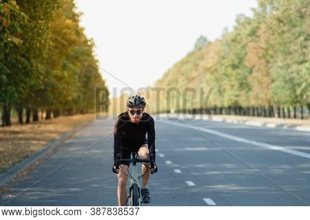 Road Cyclist Exercising On A Gravel Bike. Bicycle Training Outdoors, Modern Looking Bike And Sportsm