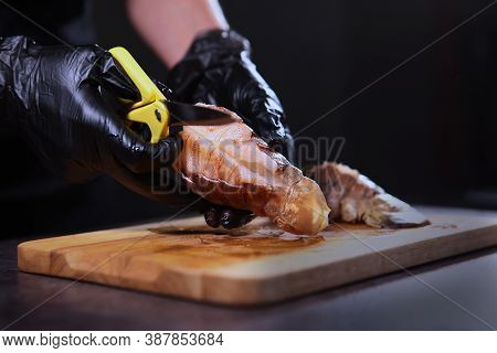 Cooking A Dish Of Langoustes. Cut The Shell Of A Lobster. Unrecognizable Photo. Only Hand. Dark Back
