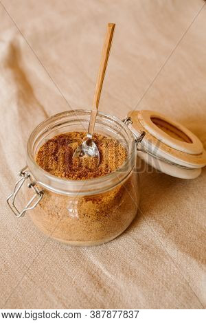 Panela Sugar Background. Close Up View Of Raw Cane Sugar In A Jar.