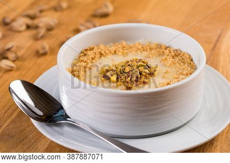 Turkish Desserts Milk Puding; Keskul, Sutlac On Wood Board