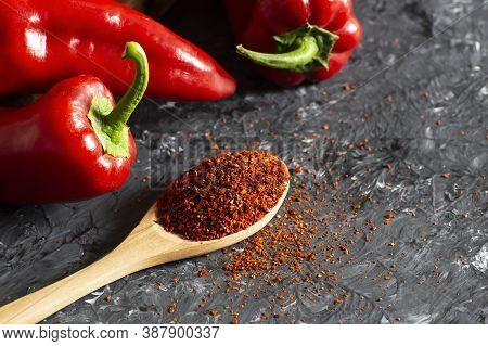 Fresh Capia Peppers And Chili Flakes Or Powder In Wooden Spoon On Grey Rustic Table, Healthy Turkish