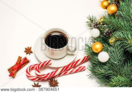 Christmas Layout With A Cup Of Coffee On The Table, Decorations, Fir Branches, Candy And Cinnamon. N