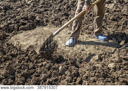 Diggin Soil With Shovel In Vegetable Garden. Abstract: Unfinished Work.