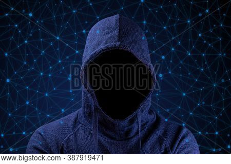 Hacker In The Hood Without A Face On A Background Of A Computer Network.  Darknet.  Harvesting.