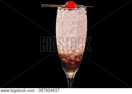 Colorful Kir Royale Cocktail, With Ice Cubes In A Glass, Isolated On Black Background