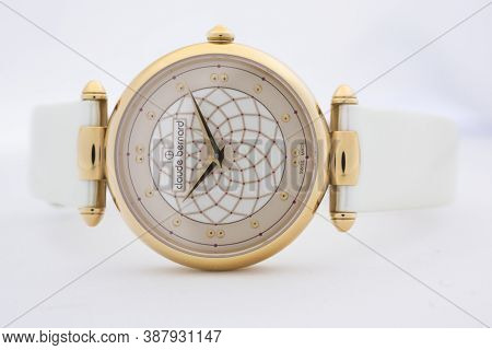 Geneve, Switzerland 01.10.2020 - Claude Bernard Swiss Made Watch Gold Pvd Coating Leather Strap Isol