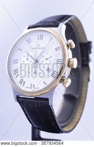 Geneve, Switzerland 01.10.2020 - Claude Bernard Man Swiss Made Watch Gold Pvd Coating White Dial Lea