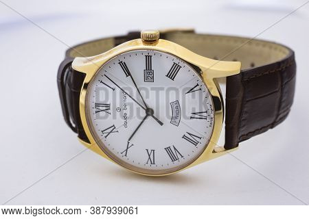 Geneve, Switzerland 01.10.2020 - Claude Bernard Man Swiss Made Watch Gold Pvd Coating White Dial Lea