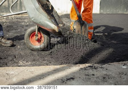 Asphalt Rammer. Laying The Road Surface. Creation Of Parking. The Worker Levels The Road Surface. Ho