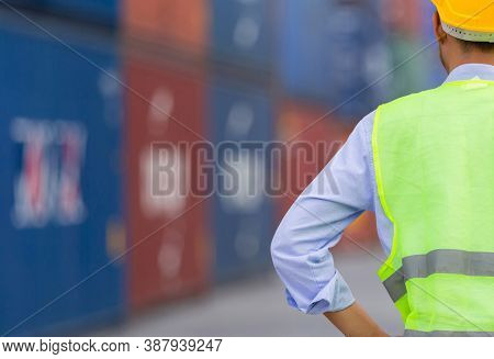 Engineer Man In Hard Hat And Safety Vest Stainding At Containers Cargo, Factory Worker Checking Cont