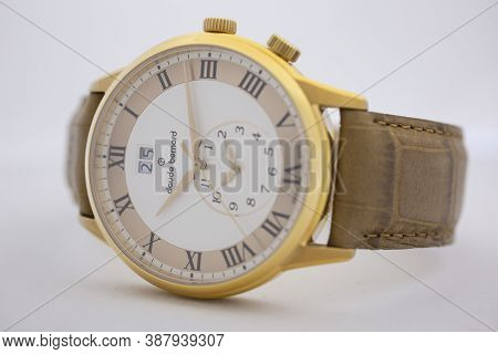 Geneve, Switzerland 01.10.2020 - Claude Bernard Man Swiss Made Watch Gold Pvd Coating White Dial Lea