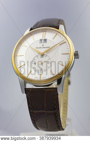 Geneve, Switzerland 01.10.2020 - Claude Bernard Man Swiss Made Watch Gold Pvd Coating White Dial Lea