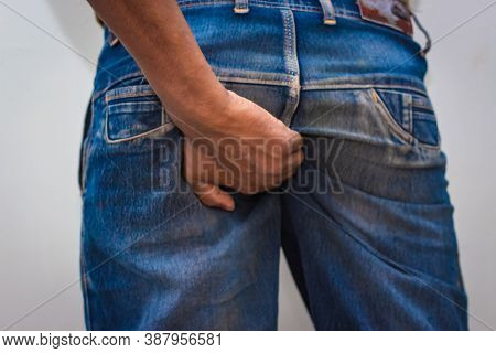 Itching - Butt Rashes. Man Rude Scratches His Buttocks Indoor - Not Something To Do In Outside Publi