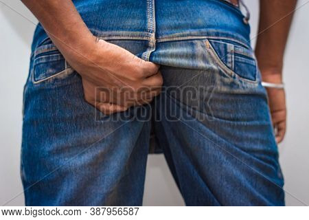 Itching - Butt Rashes. Man Rude Scratches His Buttocks Indoor - Not Something To Do In Outside Publi