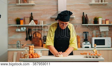 Grandmother Preparing Wheat Homemade Bread Wearing Chef Bonete. Retired Elderly Baker With Bonete Mi