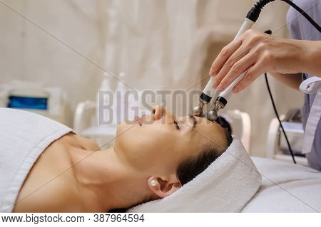 Lateral View Of Woman Facial Massage Spa Procedure. Electric Stimulation Facial Skin Care. Microcurr