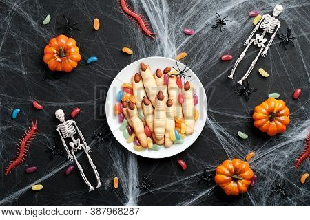 Halloween Cookies In Form Of Witches Hand Fingers, Pumpkins, Colorful Candies, Skeletons, Spiderweb 