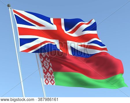 Two Waving State Flags Of United Kingdom And Belarus On The Blue Sky. High - Quality Business Backgr