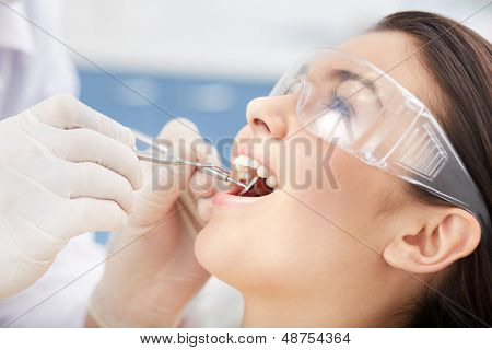 Close-up of girl with open mouth during oral checkup at the dentistÃ?ÃÂ¢??s