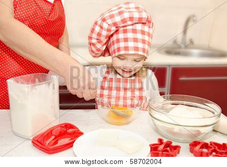 Little Girl And Grandmother Stirrring Cookie Doug