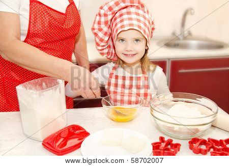 Little Girl And Grandmother Stirrring Cookie Dough