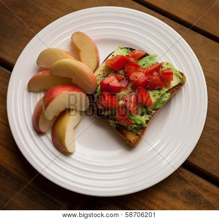 Plate Of Tomato And Avocado On Toast With Apple Slices