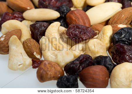 mixed nuts and dried fruits isolated on white background