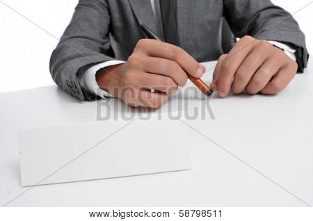 a man wearing a suit sitting in a desk with a blank signboard in front of him with a copy-space